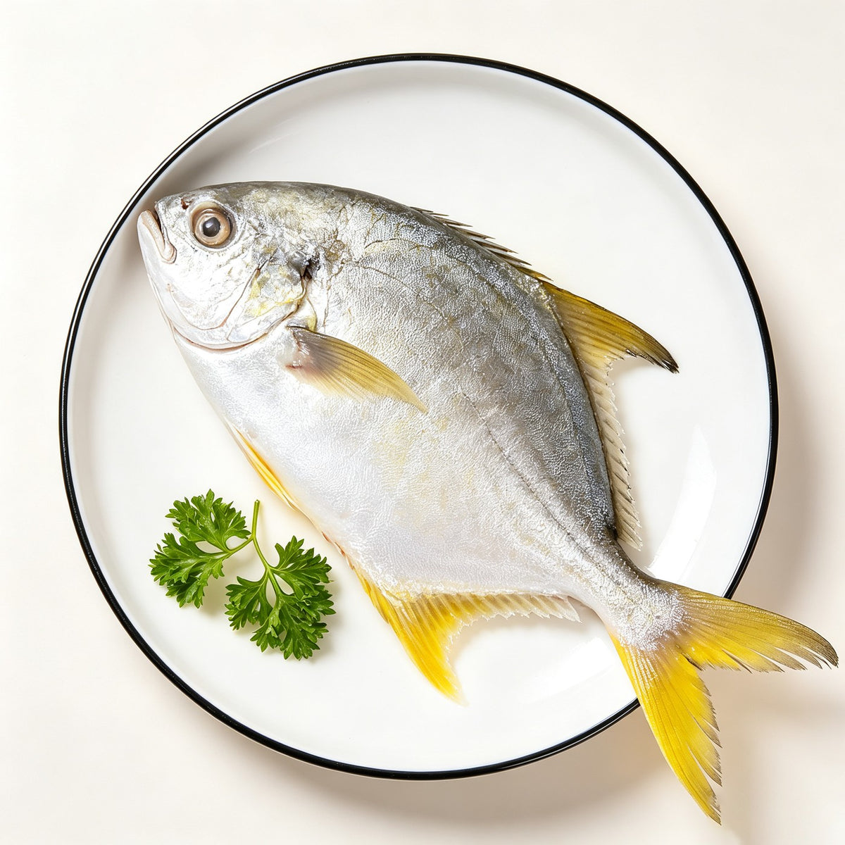 Whole wild-caught sea bream with golden-yellow fins resting on crushed ice (view 2)