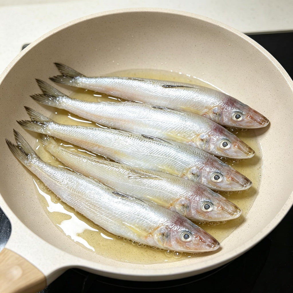 Slender silver sillago fish arranged in a row on ice (view 2)