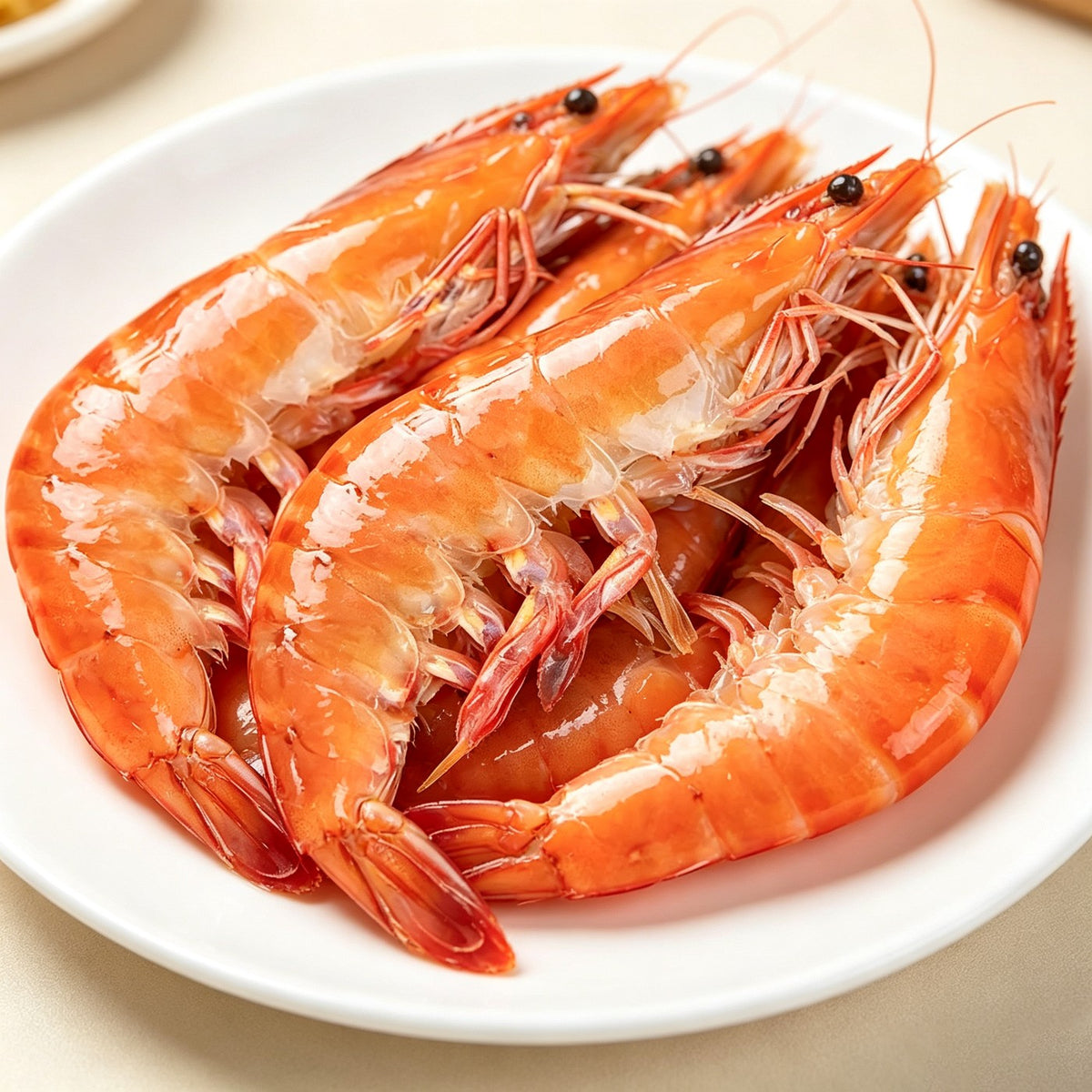 Jumbo prawns with shells intact laid out on crushed ice