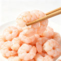 Plump peeled shrimp meat piled in a white bowl