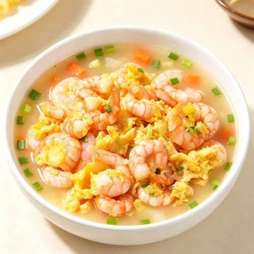 Plump peeled shrimp meat piled in a white bowl (view 2)
