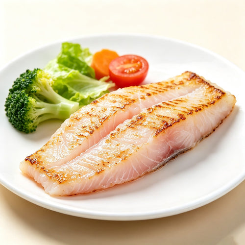 Pale boneless white fish fillets neatly overlapped on a tray (view 2)